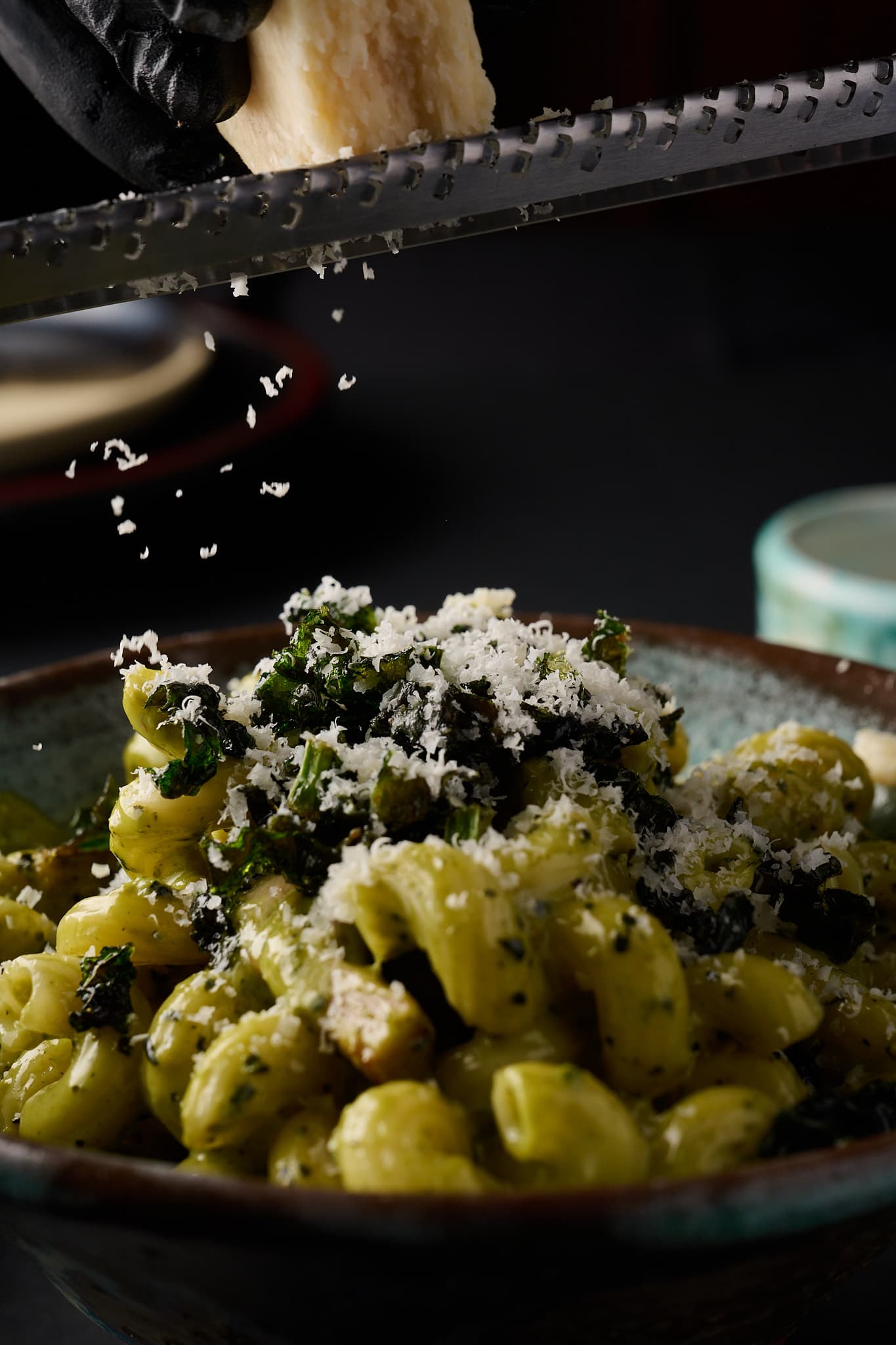 Fresh pasta with parmesan being grated tableside