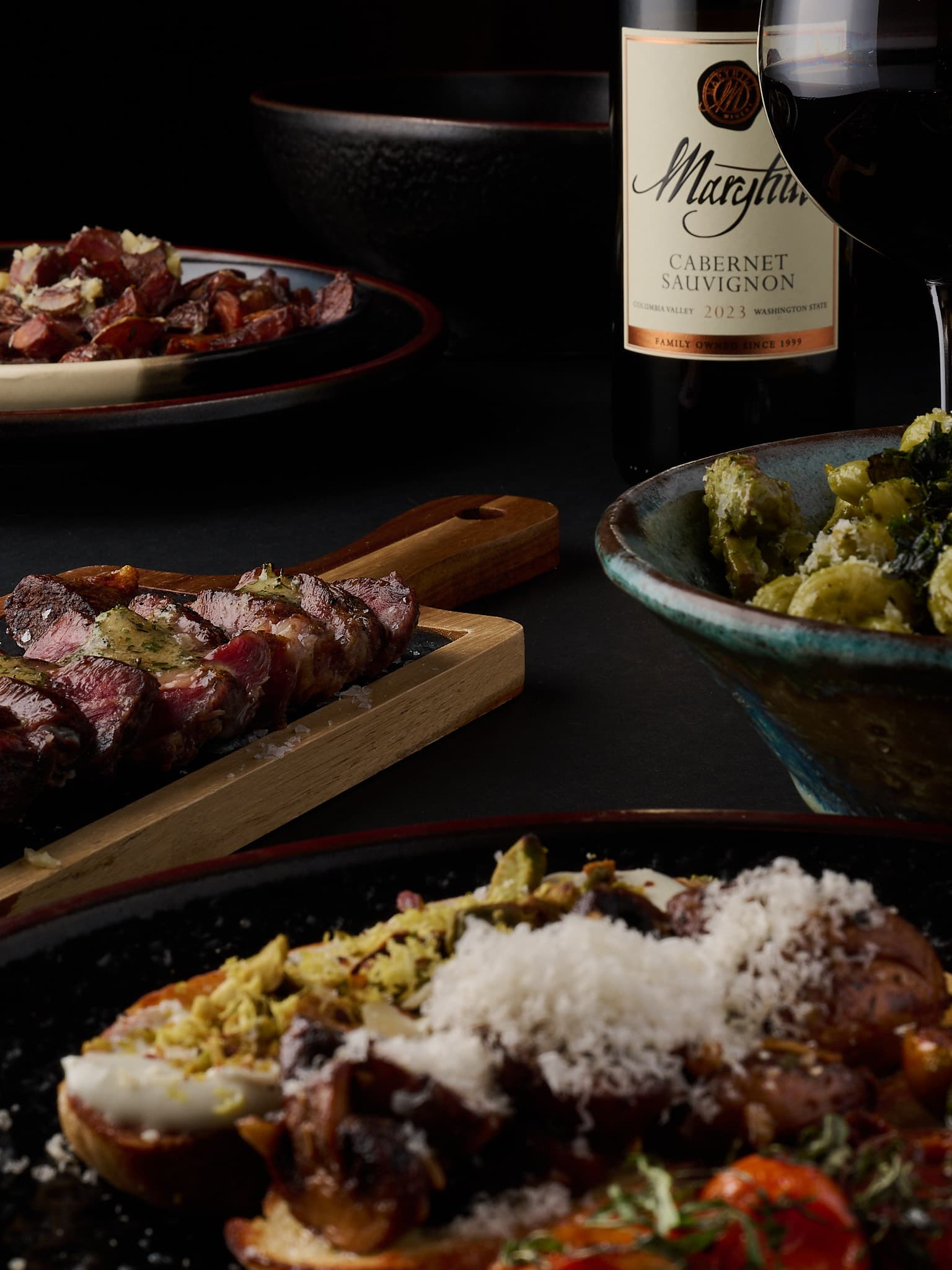 Limelight dinner spread with steak, pasta, and wine