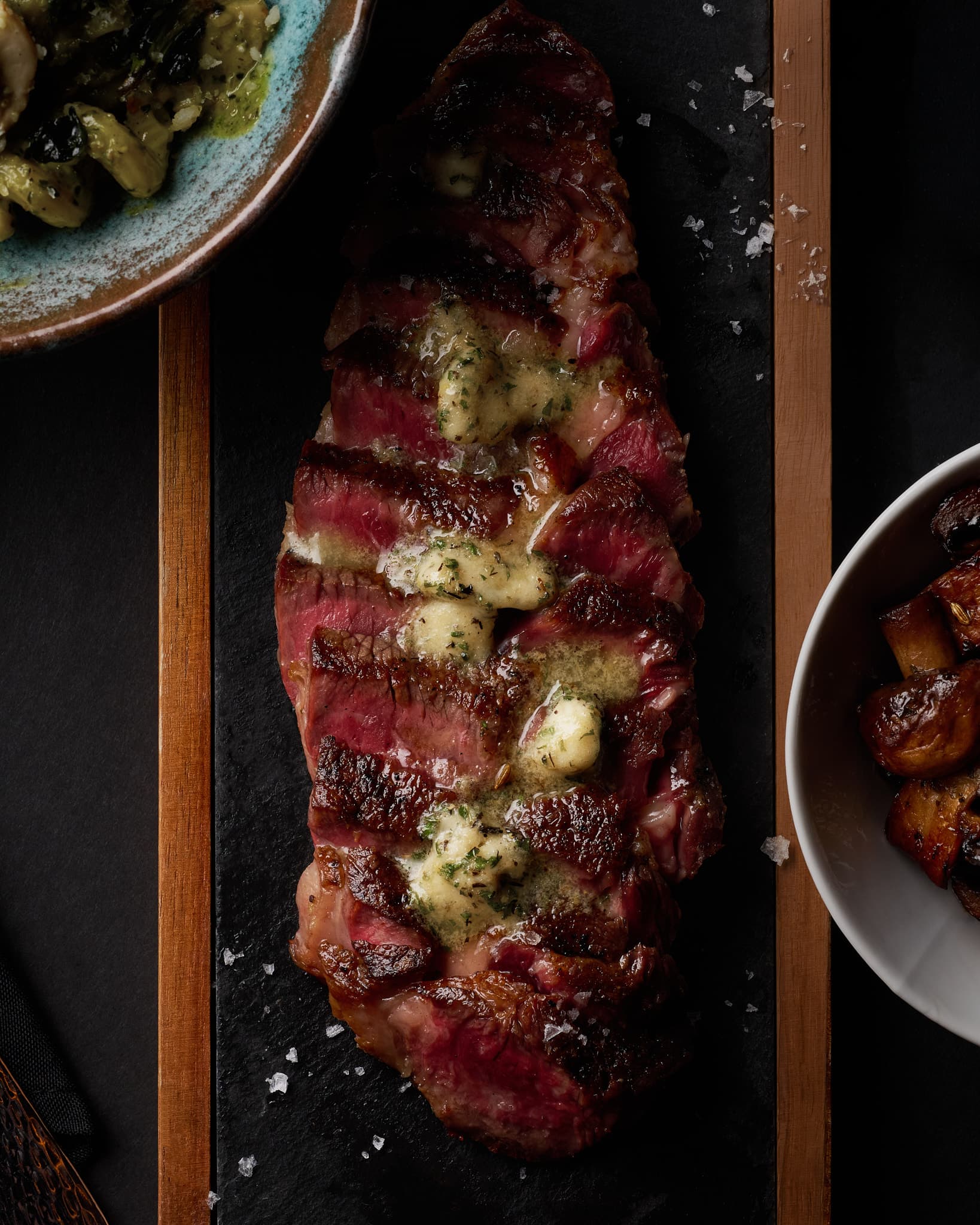 Steak with herb butter and seasonal sides