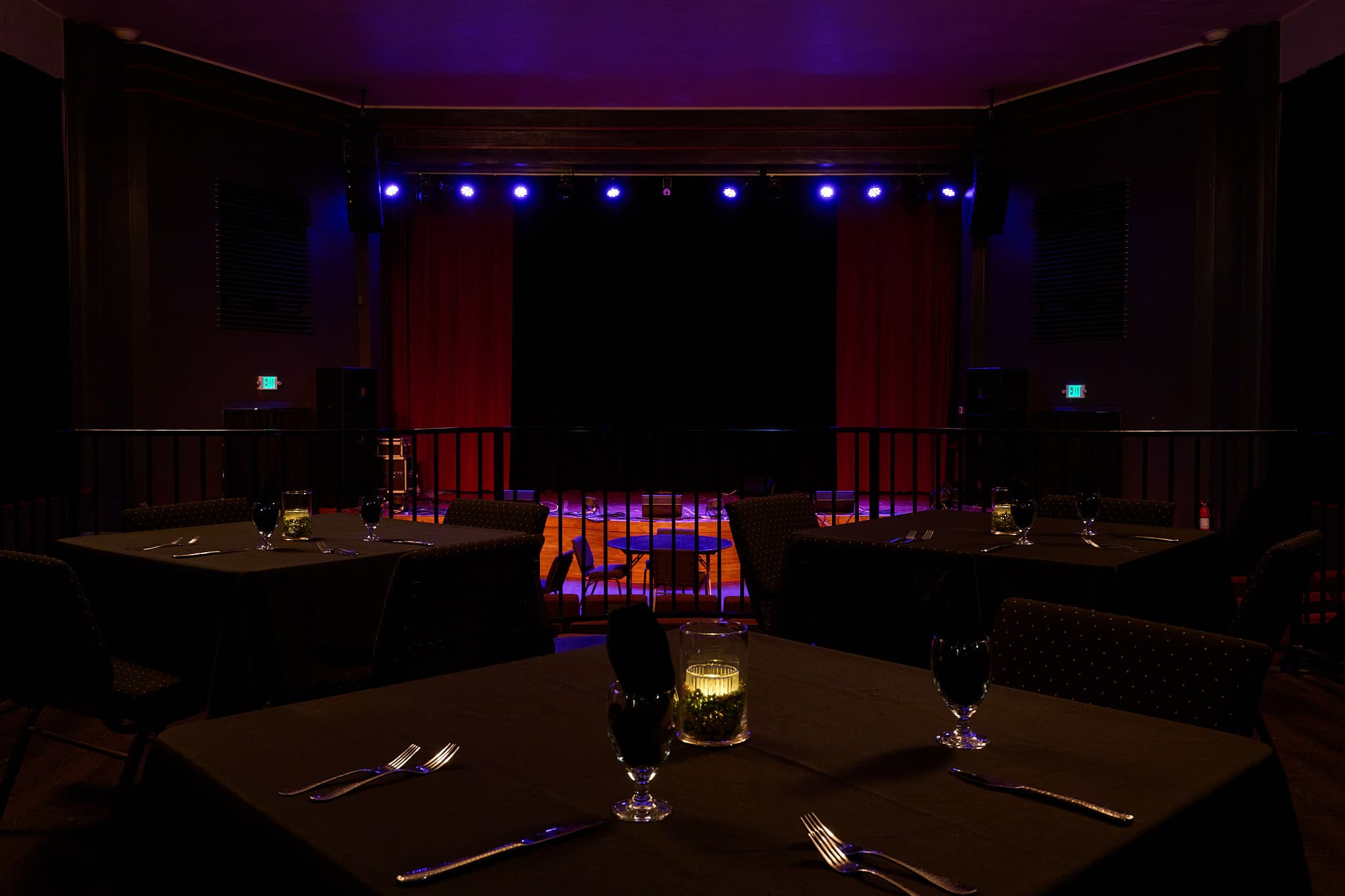 Candlelit dining tables facing the stage at the Chehalis Theater